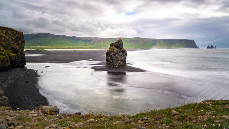 Dyrhólaey lonely black column at the beach