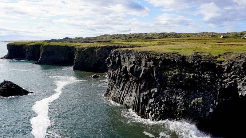 Majestic black cliffs of Arnarstapi seen on a sunny day