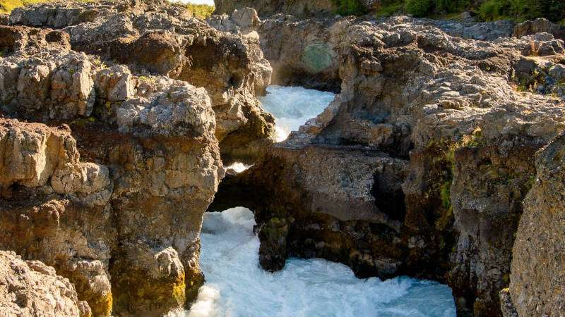 Barnafoss rapids with foamy water in a rocky canyon
