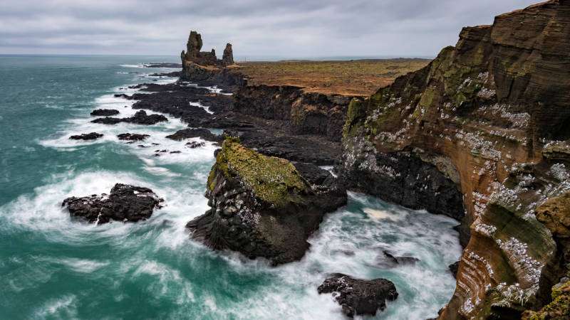 Londrangar on a cloudy day with a rough waves and plenty of nesting birds