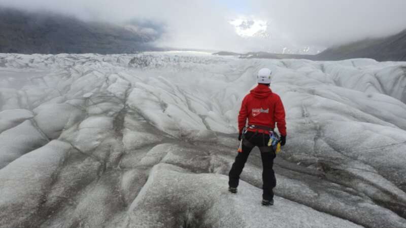 Glacier Hike Iceland, guide in a red jacket checking the path