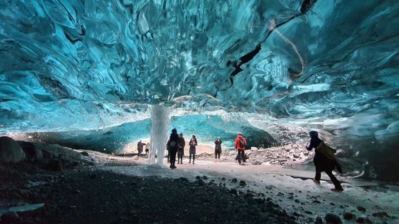 Blue Ice Cave, people on the tour inside the blue ice cave