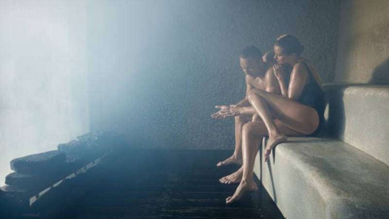 Blue lagoon, sauna with people inside relaxing