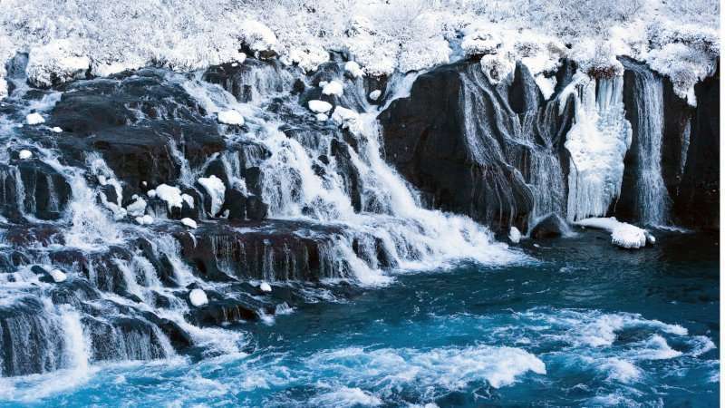 Hraunfossar Waterfall in Winter with blue water