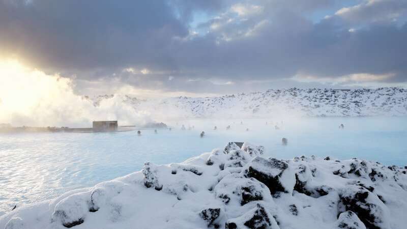Blue Lagoon in the winter time with people chilling in the steaming hot springs