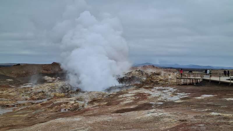Gunnuhver Hot Spring swith lots of steam coming from the ground