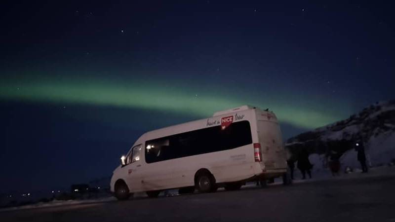 Aurora Nicetravel Tour niece travel bus with aurora in the background