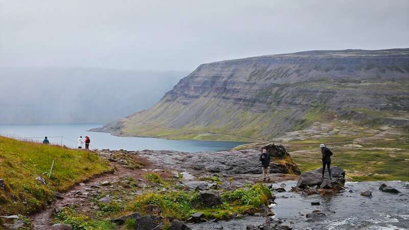 Fjord in Iceland with people and a river