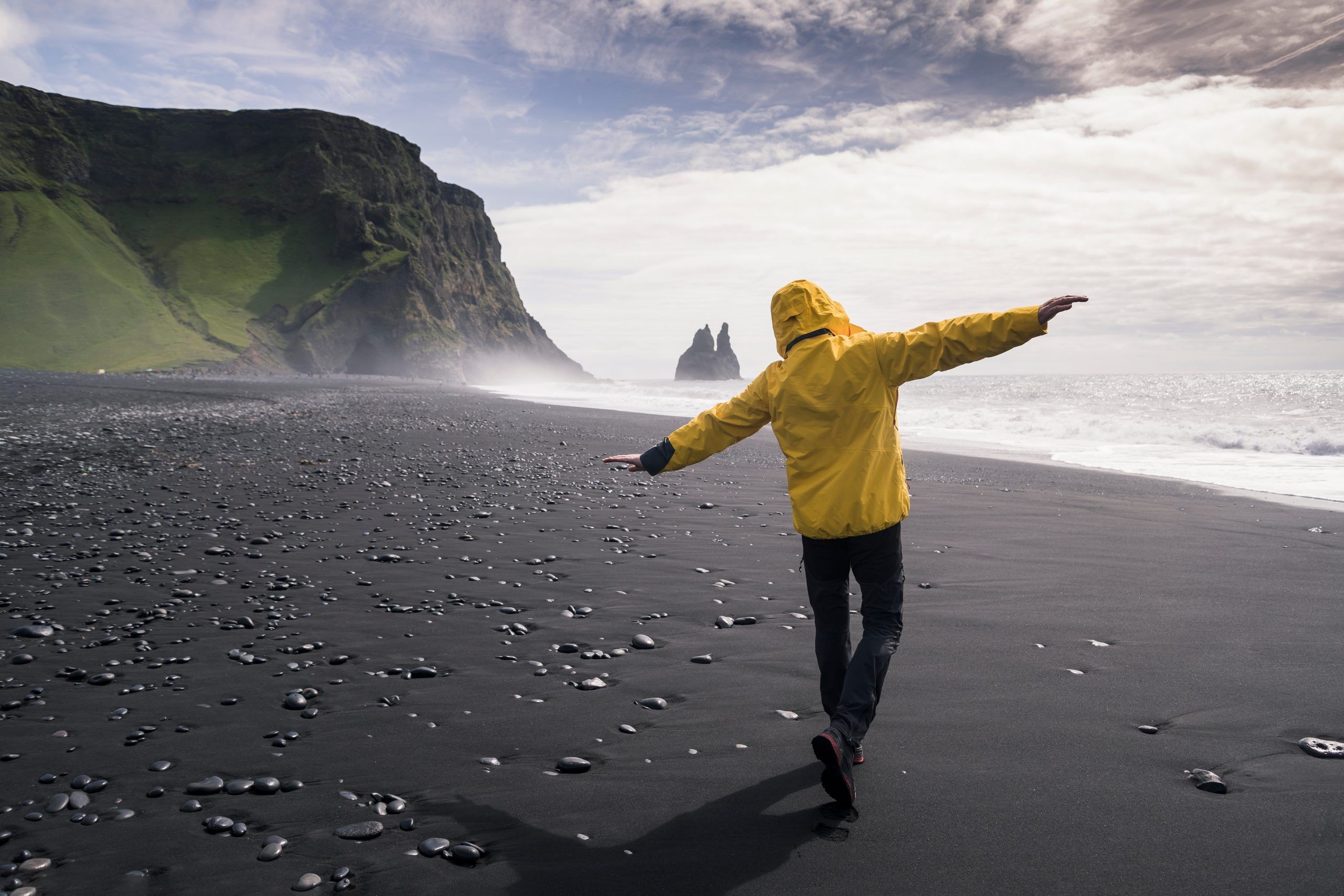 Reynisfjara black beach with man walking along